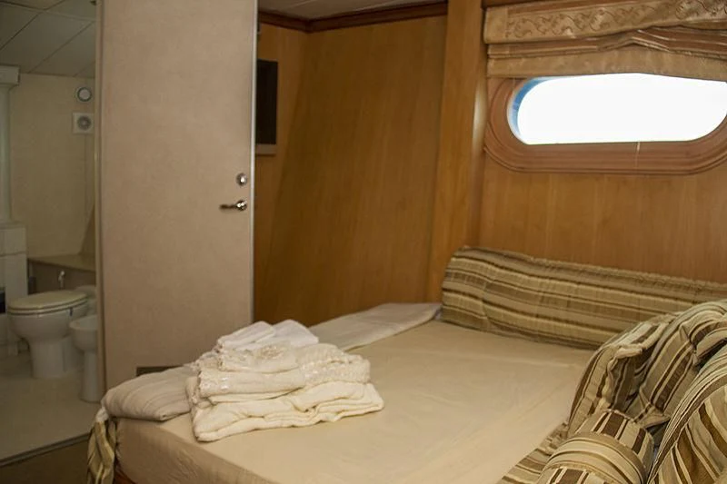 a room with a bed and a mirror aboard PRINCESS OF PALAU Yacht for Sale