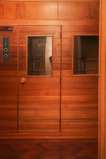 a wooden door with a light switch aboard PRINCESS OF PALAU Yacht for Sale