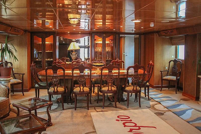 a large room with a table and chairs aboard PRINCESS OF PALAU Yacht for Sale