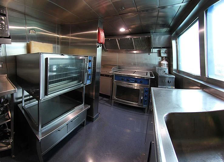 a kitchen with stainless steel appliances aboard PRINCESS OF PALAU Yacht for Sale