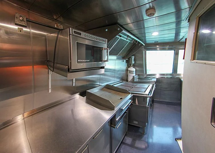 a kitchen with stainless steel appliances aboard PRINCESS OF PALAU Yacht for Sale