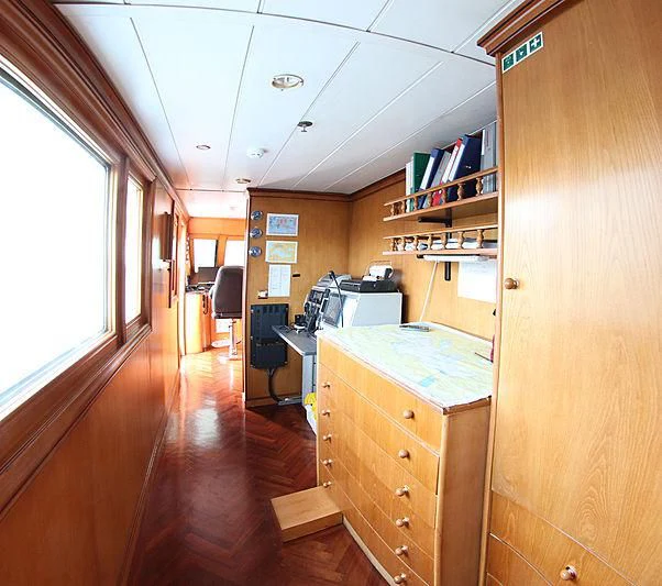 a room with a desk and a window aboard PRINCESS OF PALAU Yacht for Sale