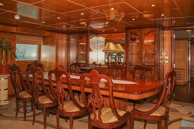 a large room with a table and chairs aboard PRINCESS OF PALAU Yacht for Sale