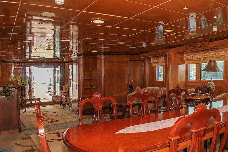 a large room with tables and chairs aboard PRINCESS OF PALAU Yacht for Sale