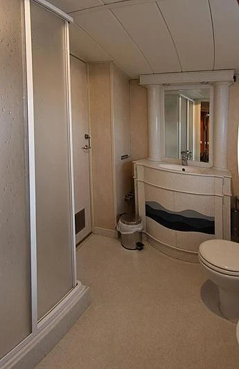 a bathroom with a tub and toilet aboard PRINCESS OF PALAU Yacht for Sale