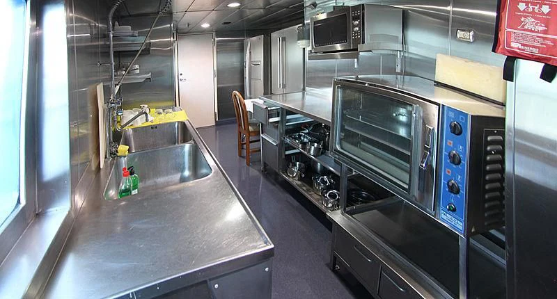 a large kitchen with stainless steel appliances aboard PRINCESS OF PALAU Yacht for Sale