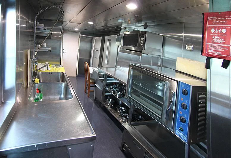 a large kitchen with stainless steel appliances aboard PRINCESS OF PALAU Yacht for Sale