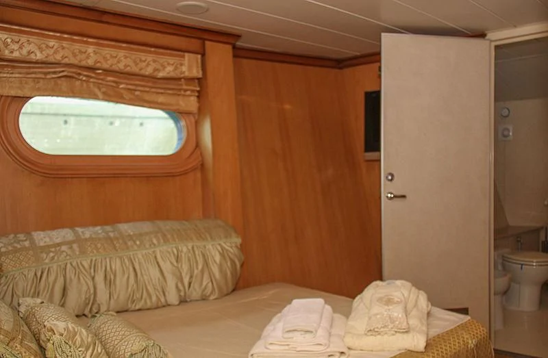 a bed in a room aboard PRINCESS OF PALAU Yacht for Sale
