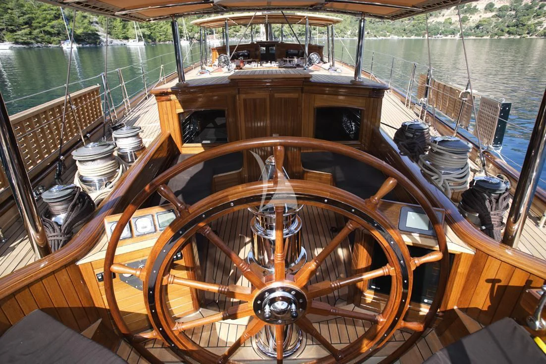 a wooden boat on a deck aboard EUGENIA VII Yacht for Sale