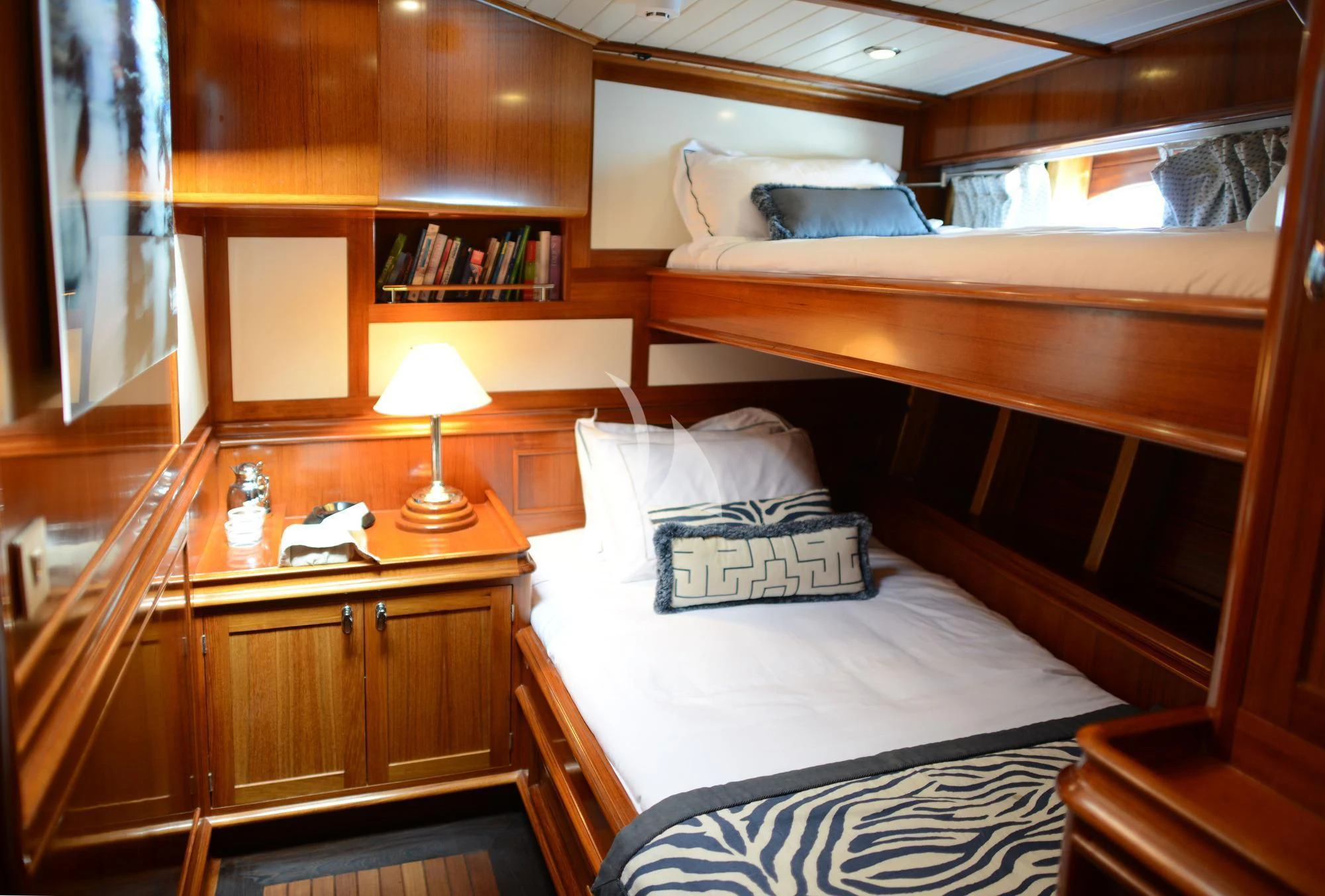 a room with a bed and a desk aboard EUGENIA VII Yacht for Sale