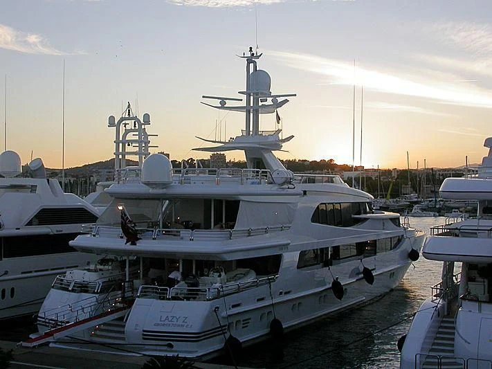 a large white boat in a harbor aboard AO Yacht for Sale
