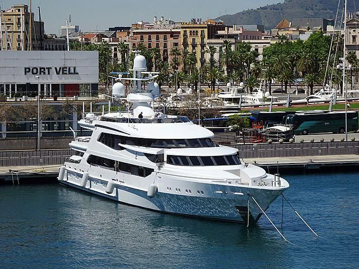 a large white boat in a harbor aboard AO Yacht for Sale