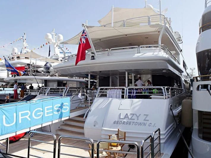 a boat with a flag on the deck aboard AO Yacht for Sale