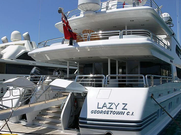 a boat with a flag on the deck aboard AO Yacht for Sale