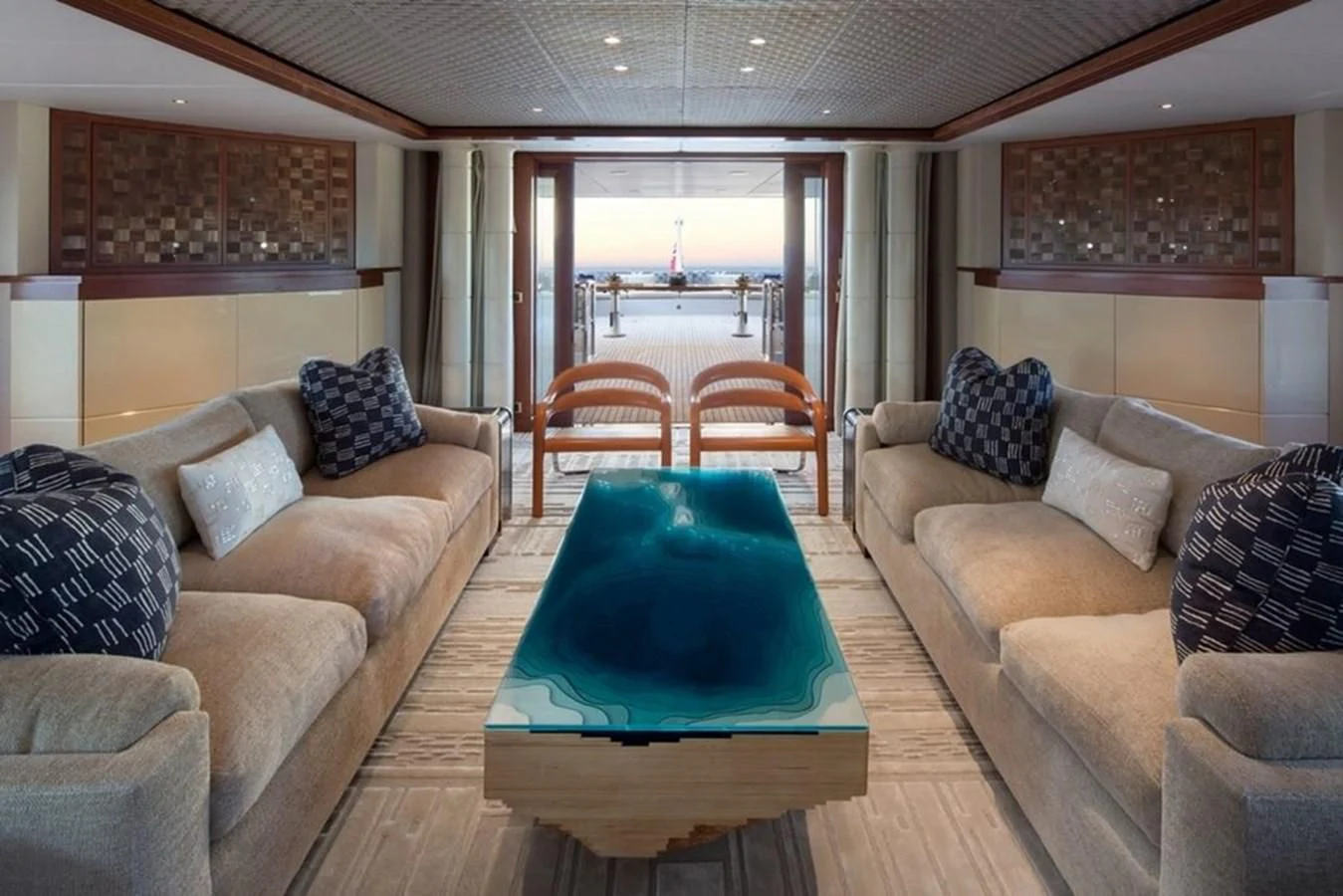 a living room with a table and chairs aboard AO Yacht for Sale