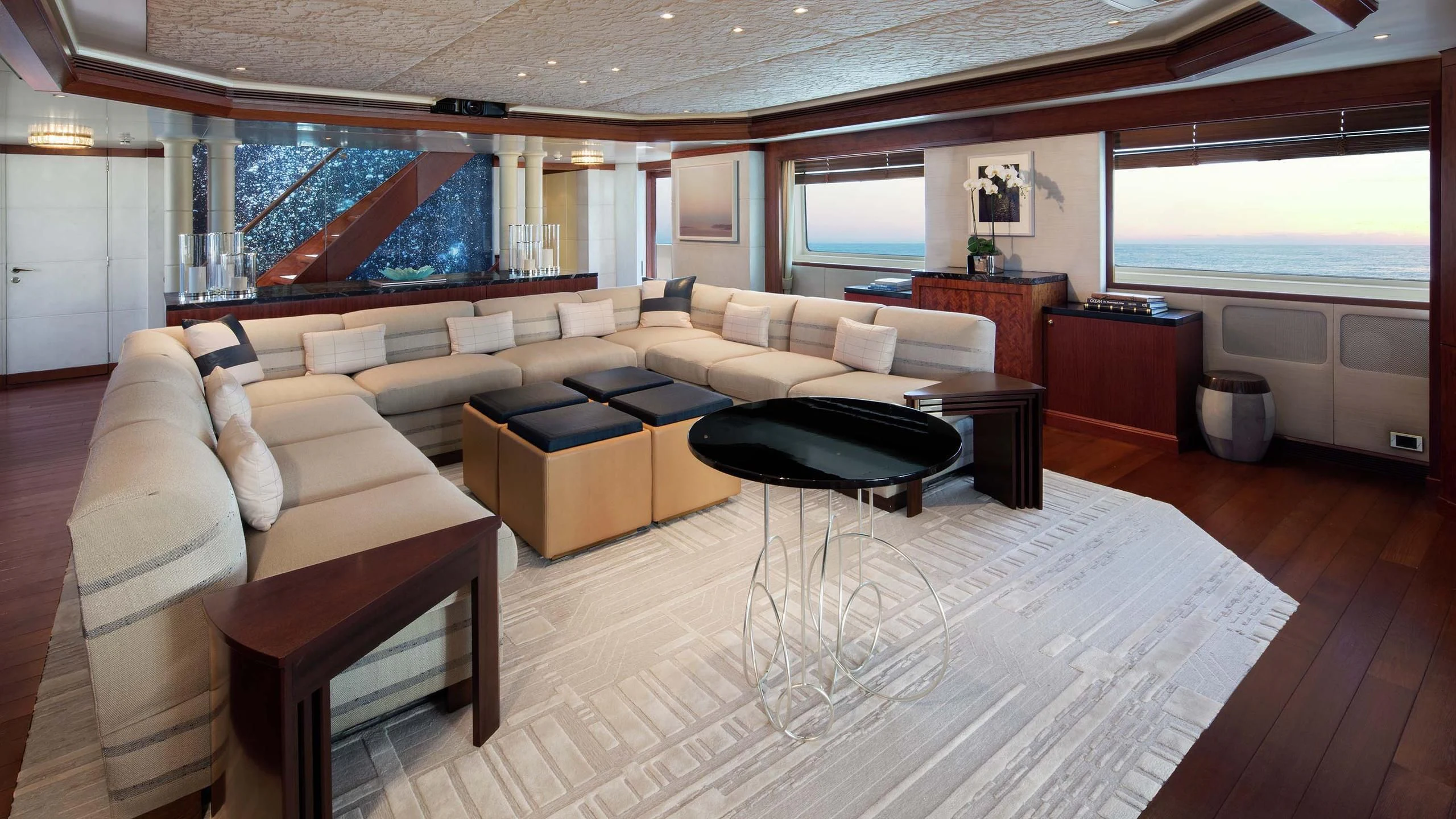 a living room with a couch and a coffee table aboard AO Yacht for Sale