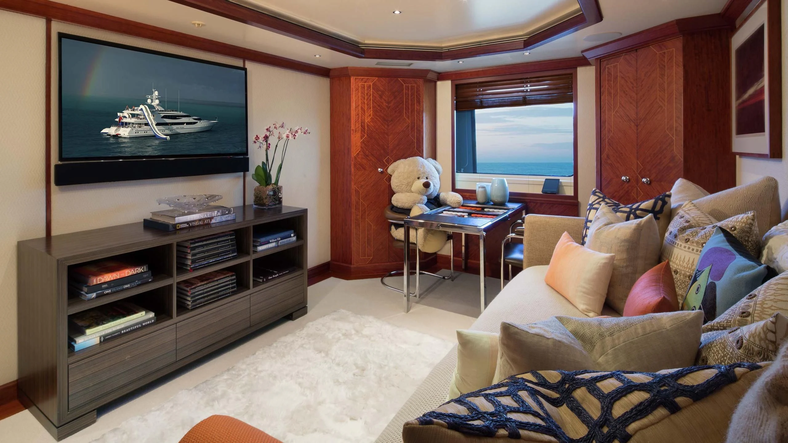 a living room with a tv and a couch aboard AO Yacht for Sale