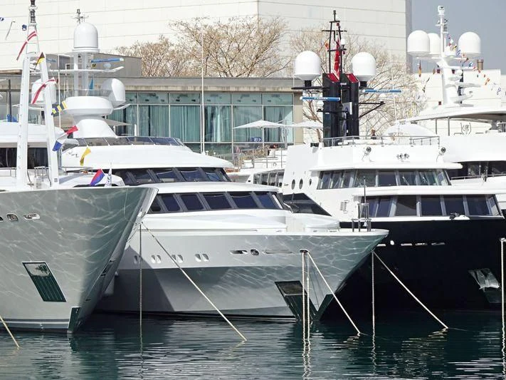 several boats docked in a harbor aboard AO Yacht for Sale
