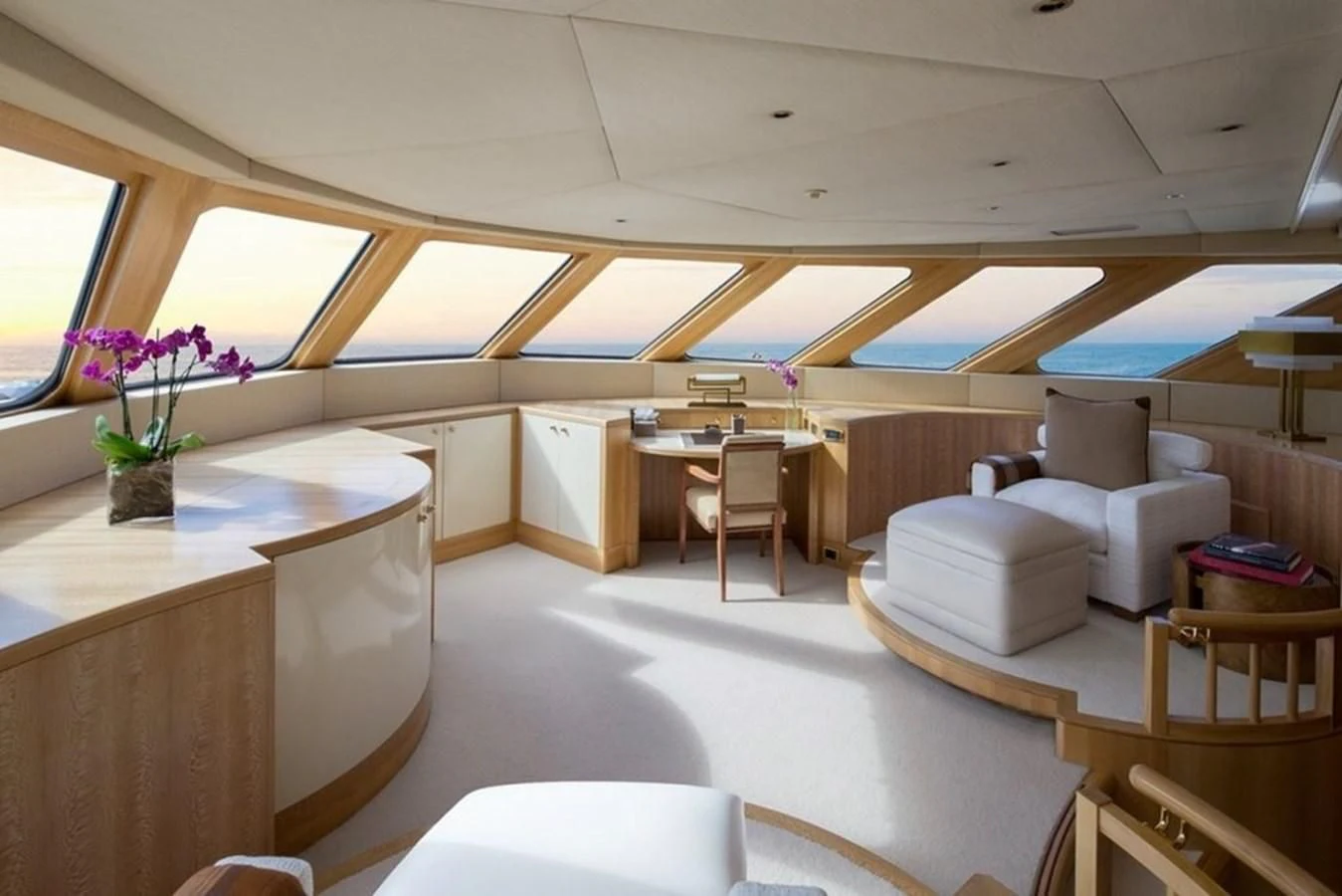 a room with tables and chairs aboard AO Yacht for Sale