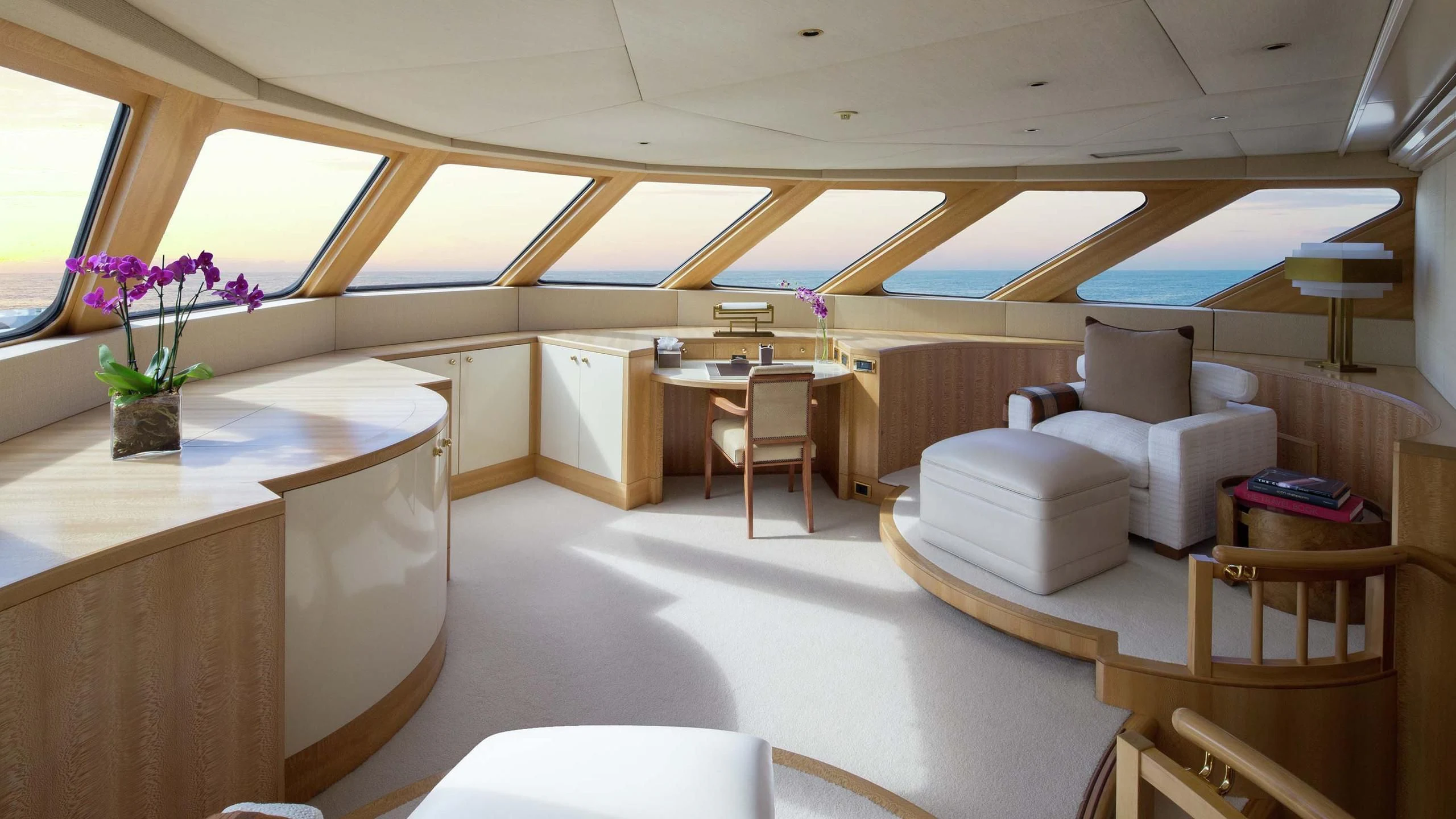 a room with a table chairs and a plant in the middle aboard AO Yacht for Sale