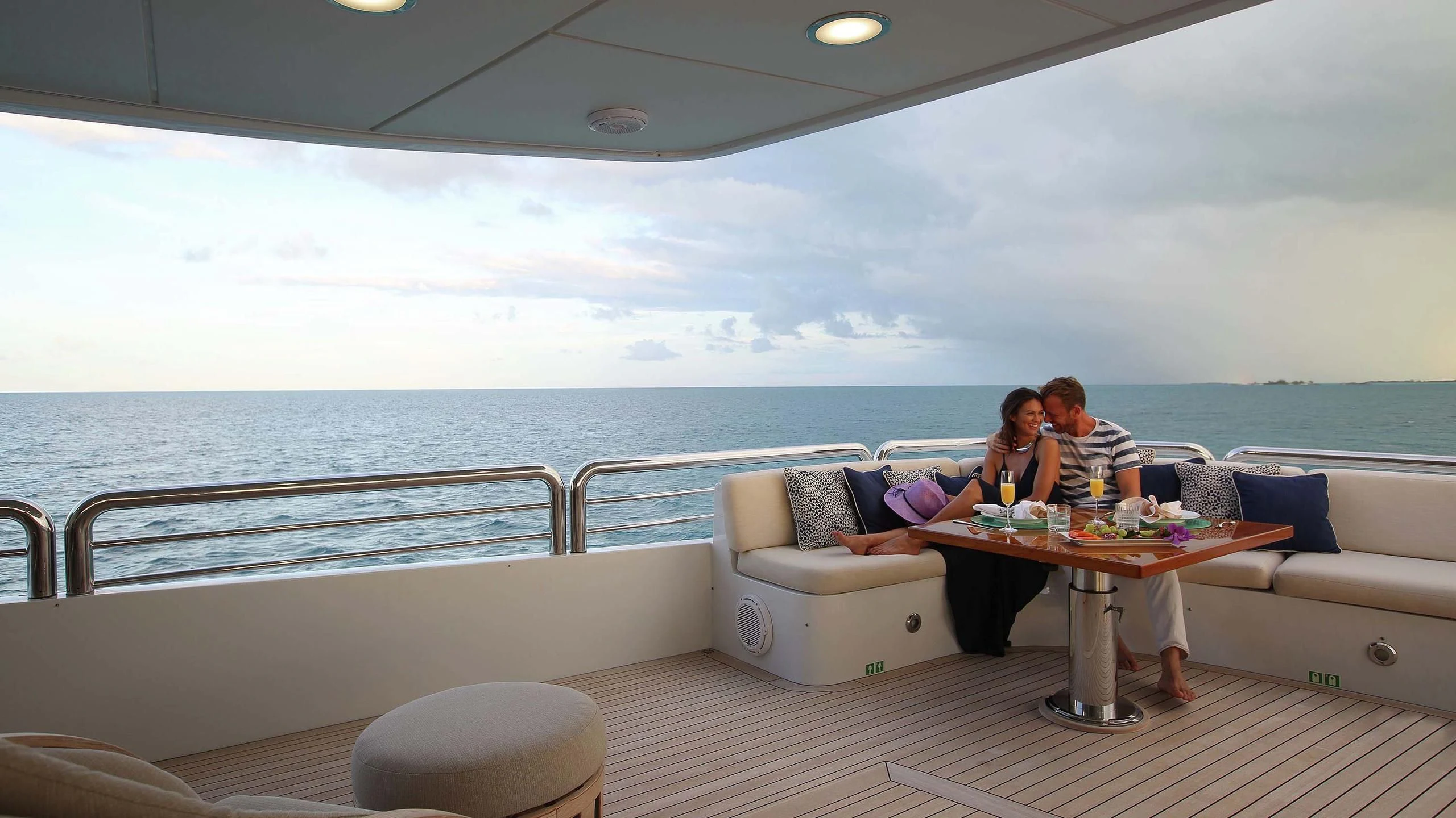a group of people sitting on a boat aboard AO Yacht for Sale