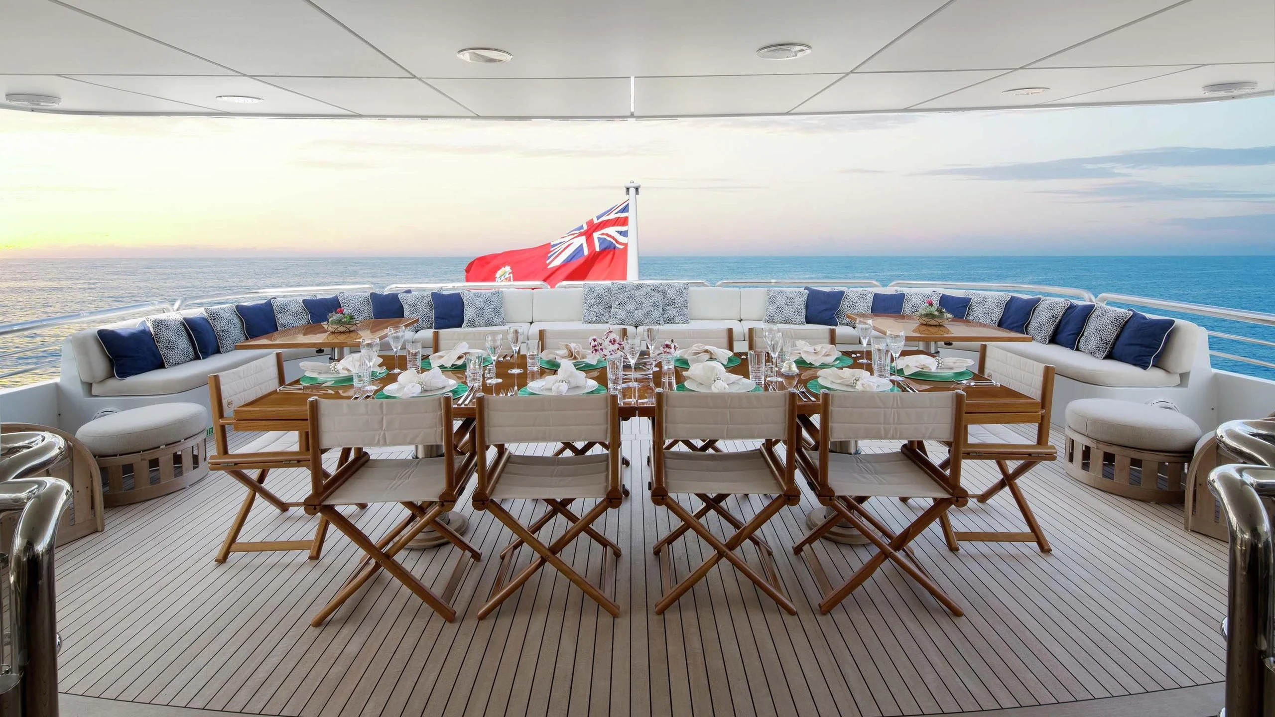 a large room with tables and chairs aboard AO Yacht for Sale