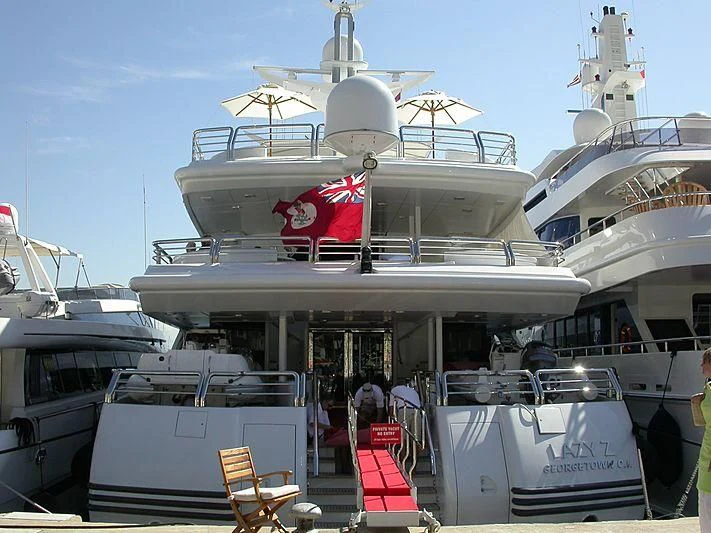 a large white boat with flags on it aboard AO Yacht for Sale