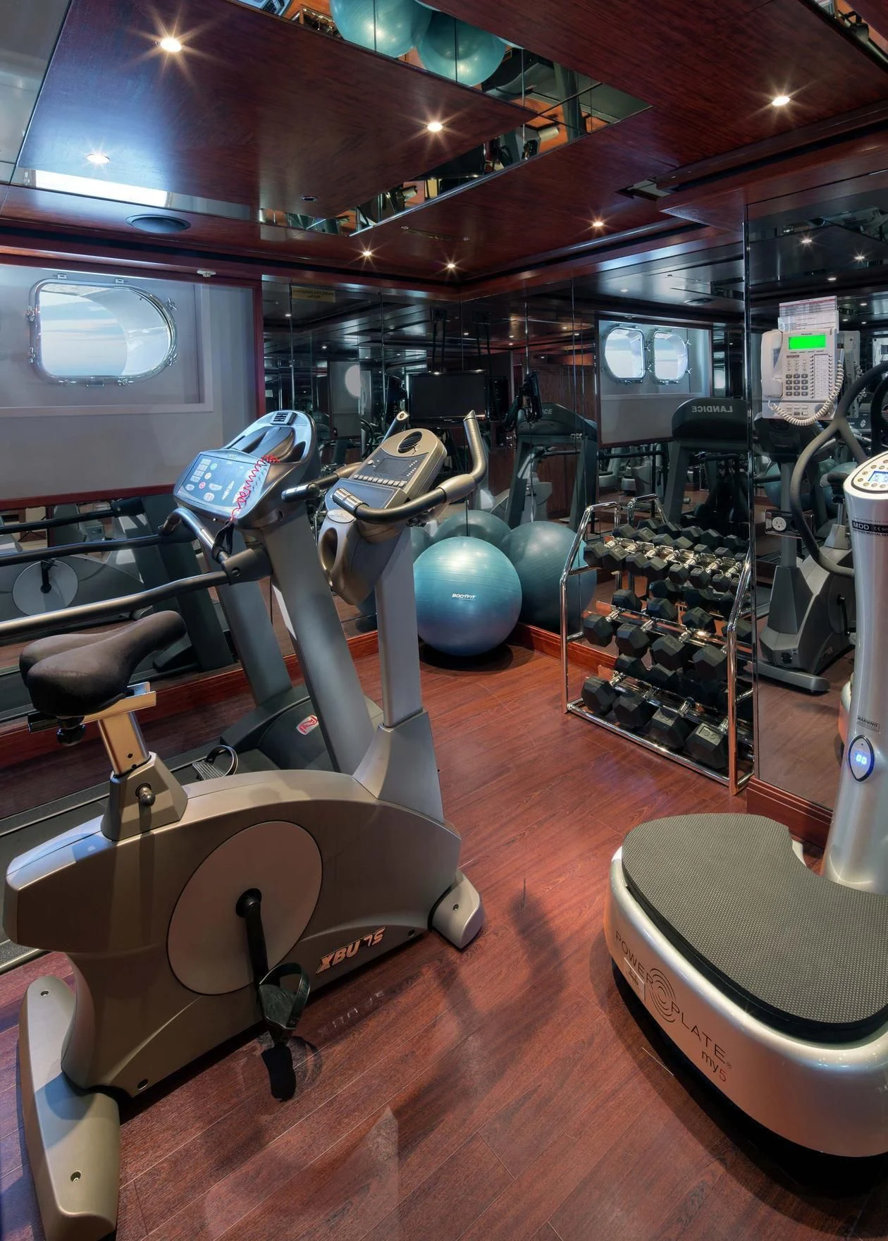 a room with many exercise equipment aboard AO Yacht for Sale