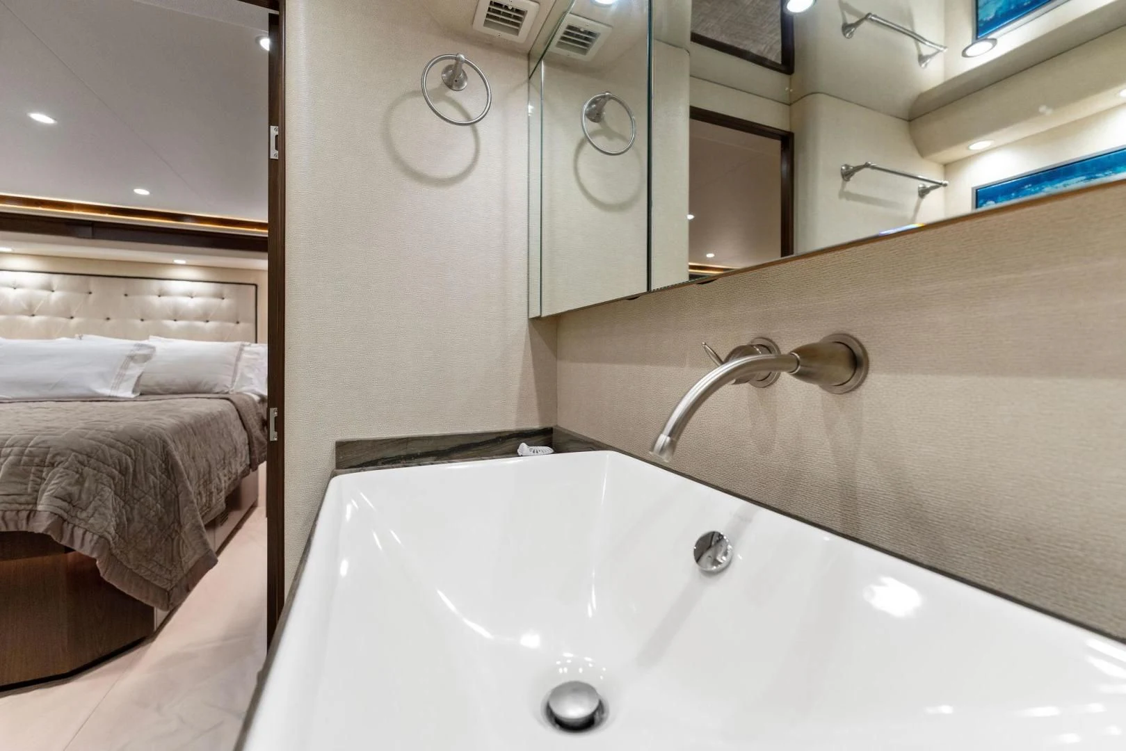 a bathroom with a sink and a bed aboard THE PROVIDER Yacht for Sale