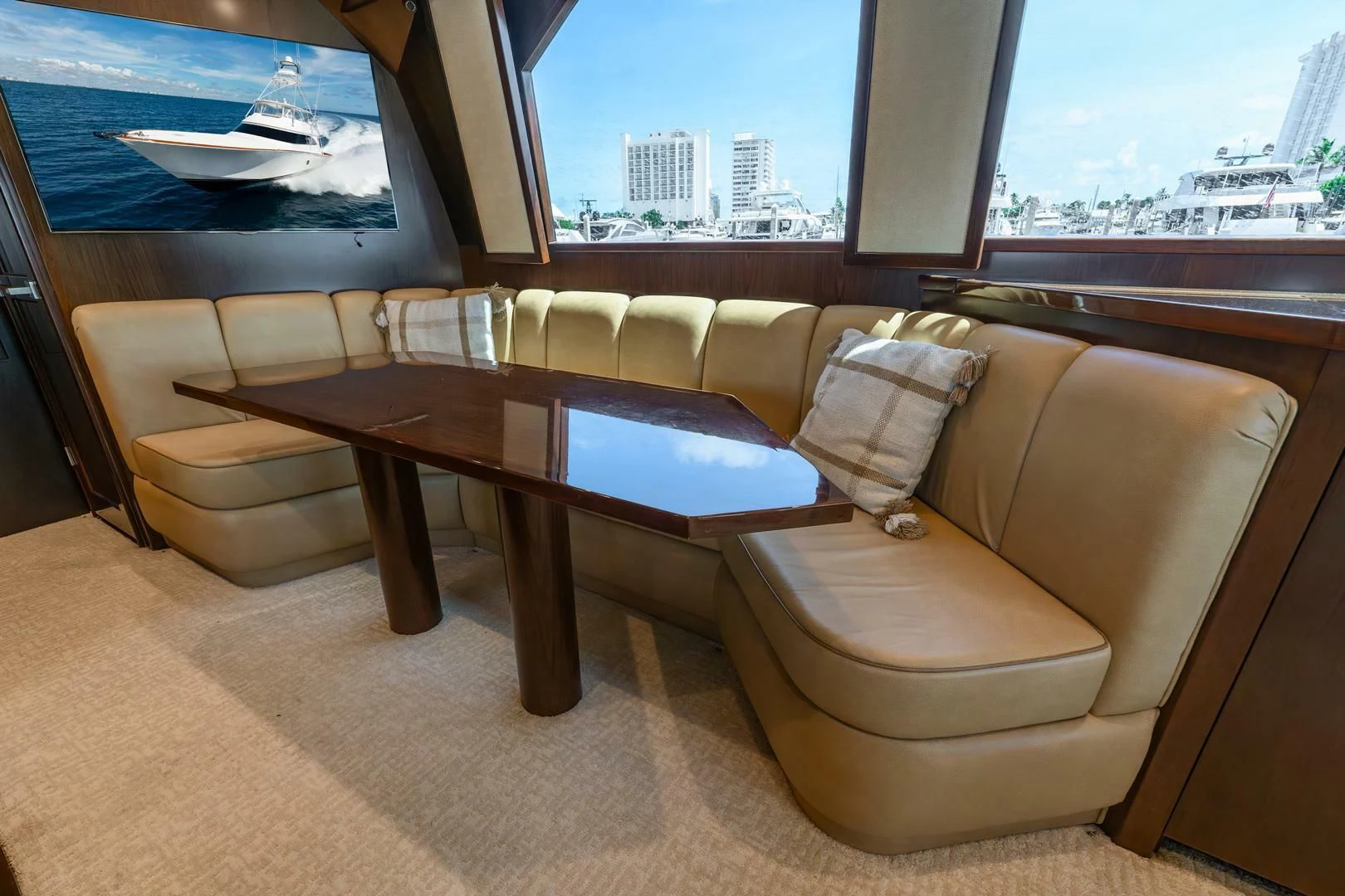 a couch and a table in a room with a window aboard THE PROVIDER Yacht for Sale