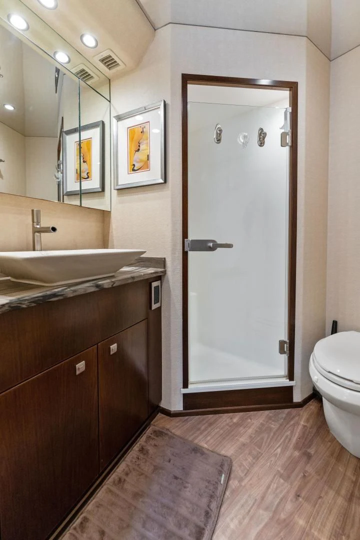 a bathroom with a glass shower door aboard THE PROVIDER Yacht for Sale
