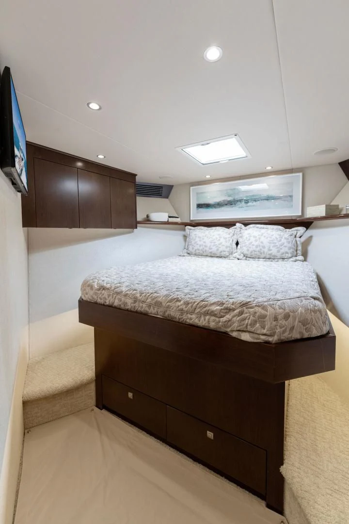 a bed with a television on the wall aboard THE PROVIDER Yacht for Sale