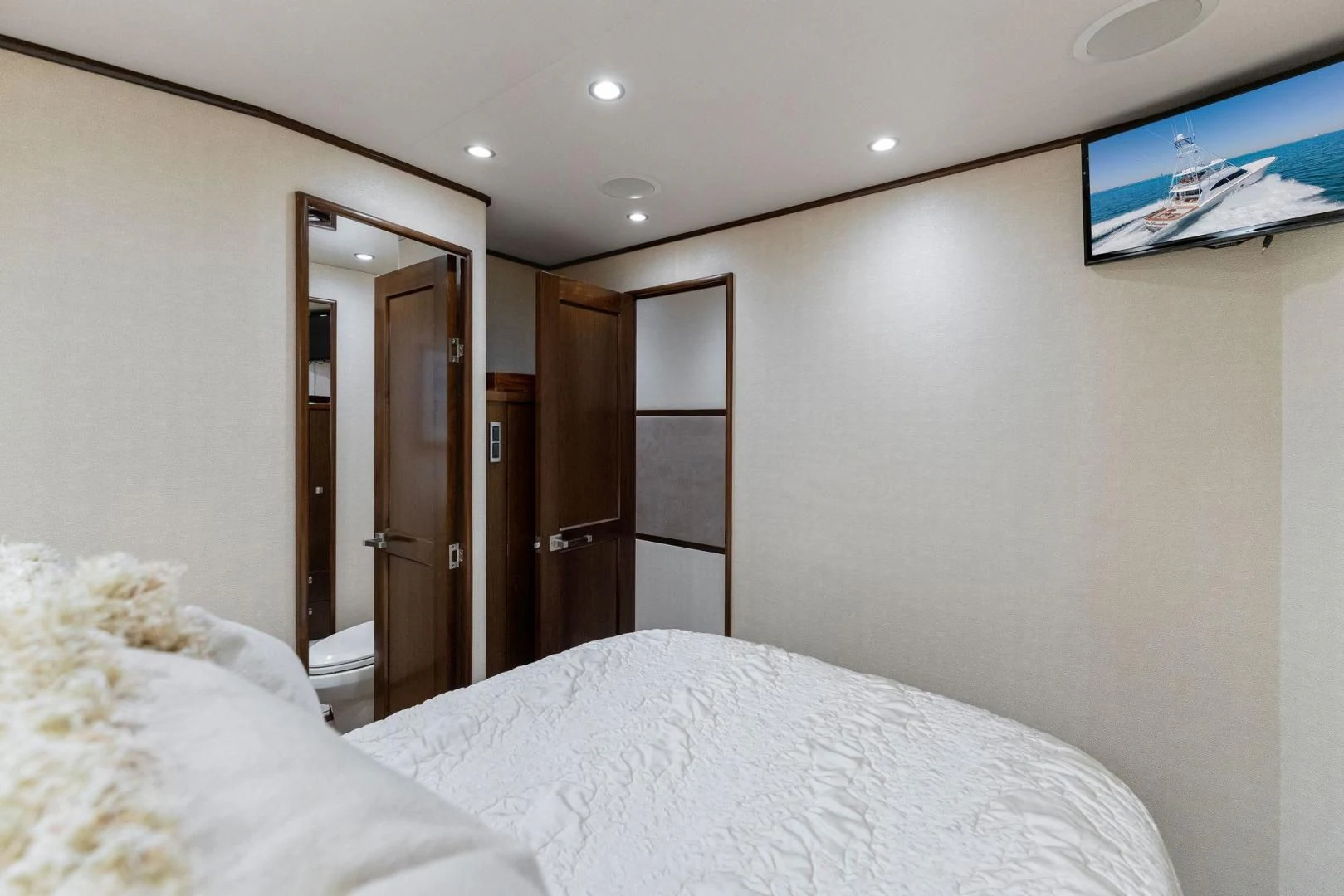 a bedroom with a bed and a closet aboard THE PROVIDER Yacht for Sale