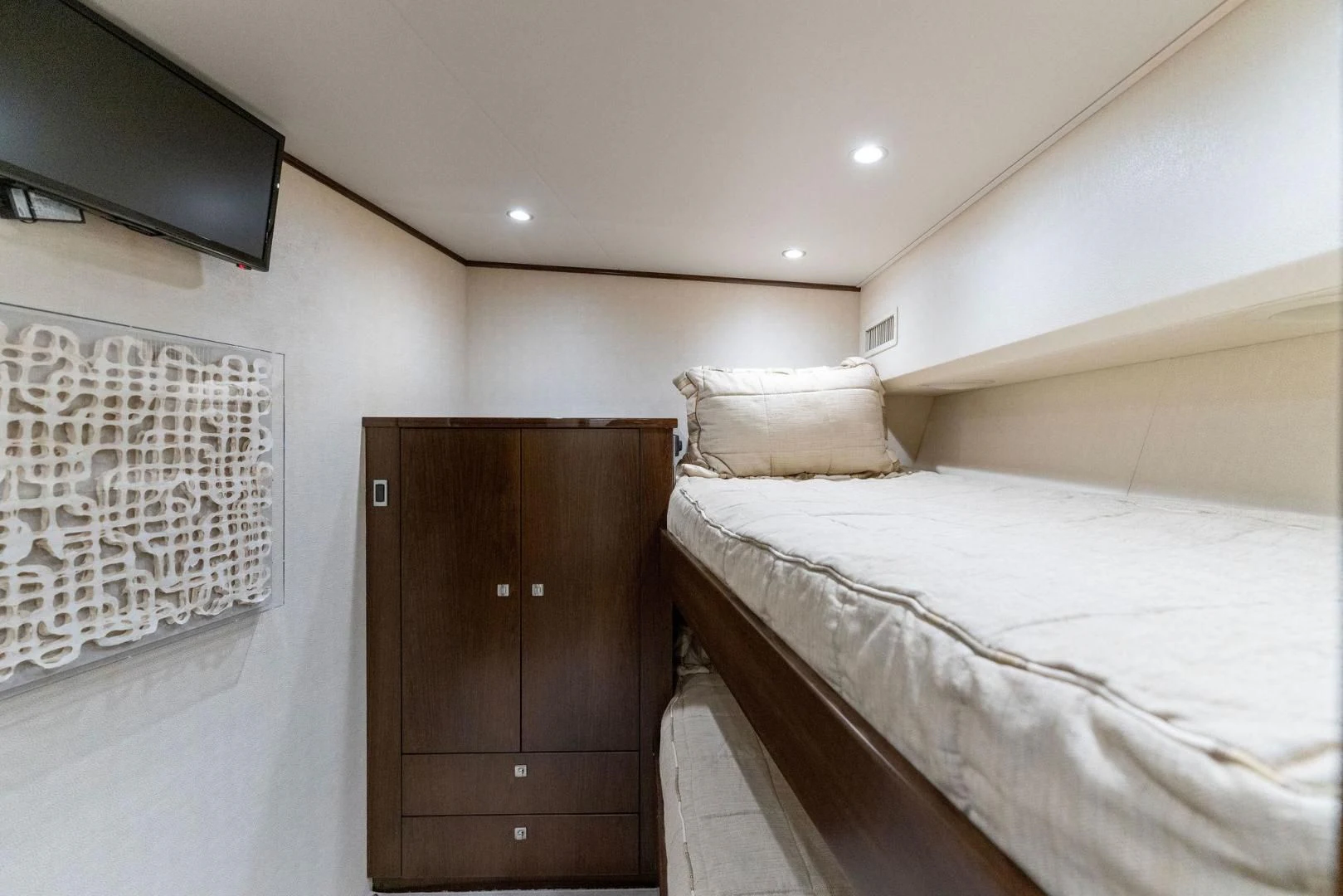 a bedroom with a bed and a television aboard THE PROVIDER Yacht for Sale