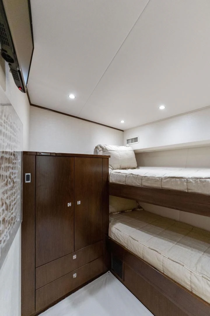 a room with a bed and a wood cabinet aboard THE PROVIDER Yacht for Sale