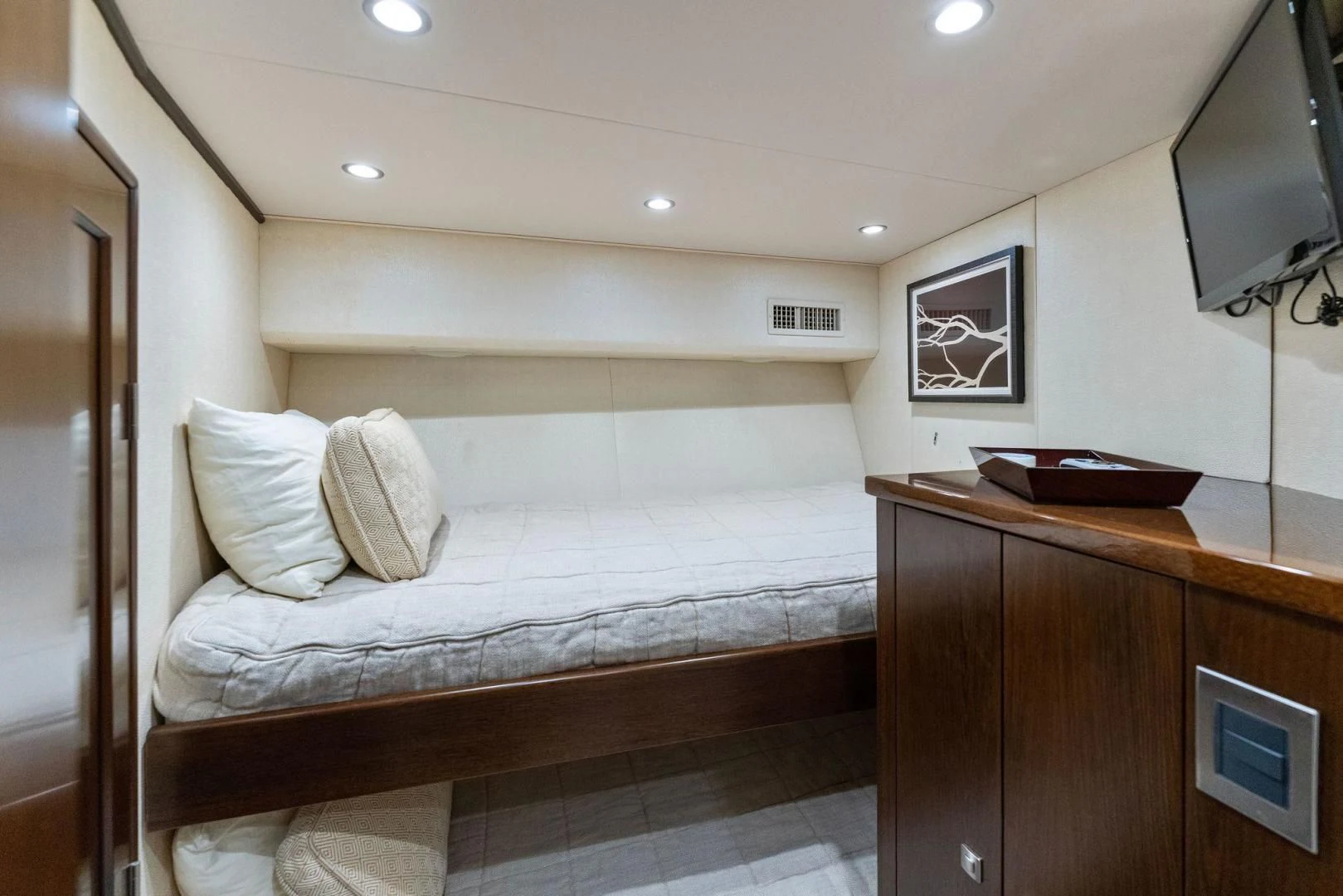 a bedroom with a bed and a television aboard THE PROVIDER Yacht for Sale