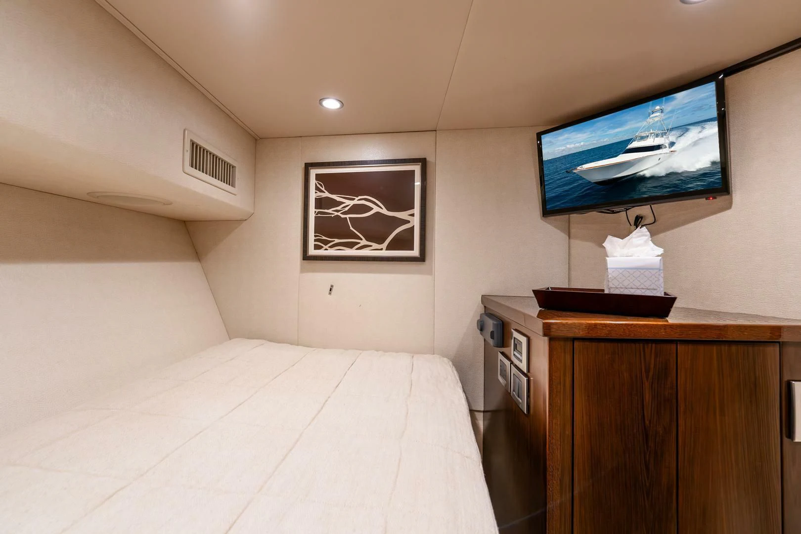 a bedroom with a bed and tv aboard THE PROVIDER Yacht for Sale