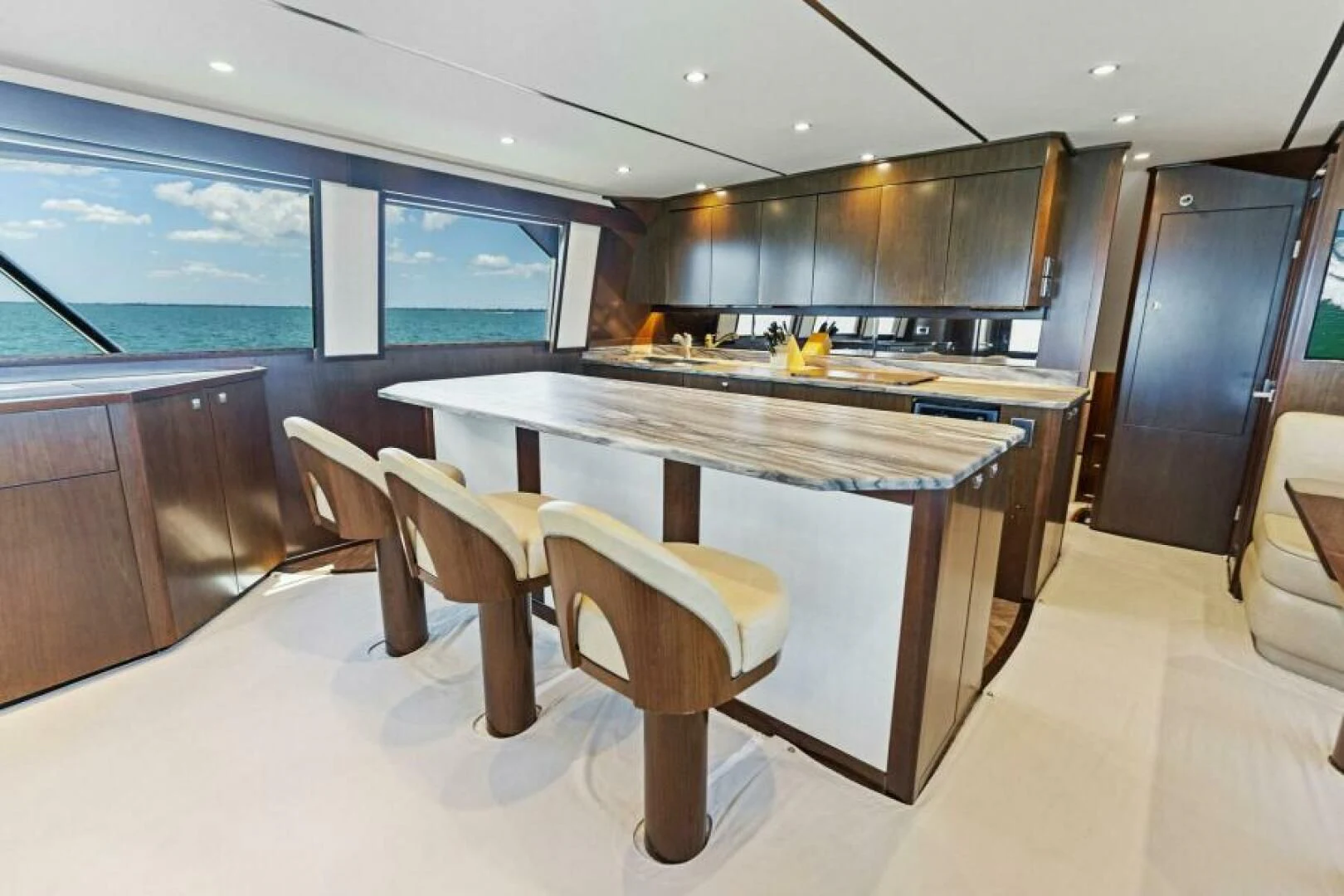 a kitchen with a bar and chairs aboard THE PROVIDER Yacht for Sale