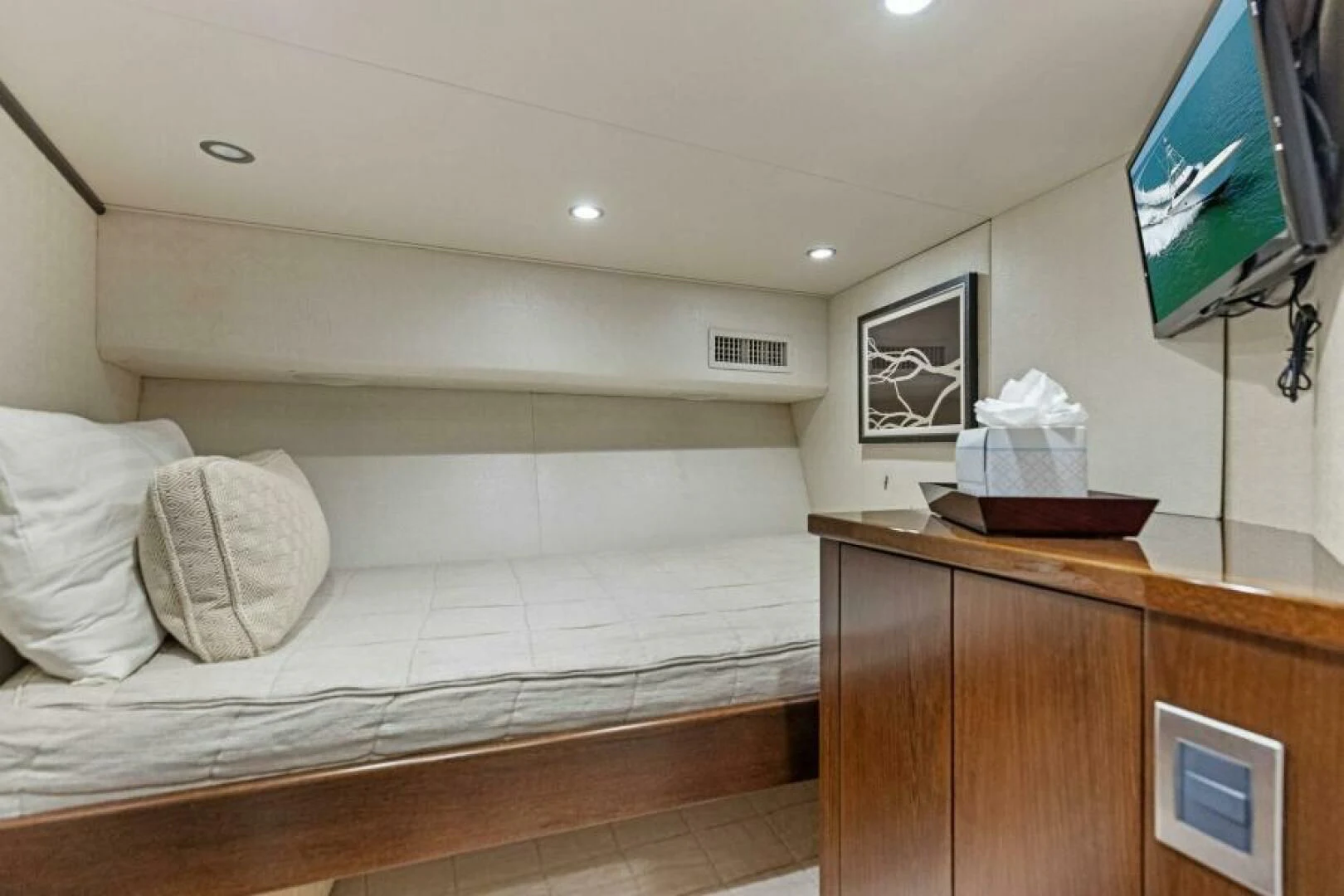 a bedroom with a bed and a television aboard THE PROVIDER Yacht for Sale