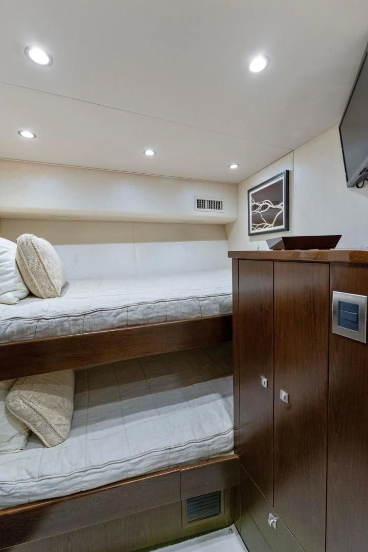 a bedroom with a bed and a desk aboard THE PROVIDER Yacht for Sale