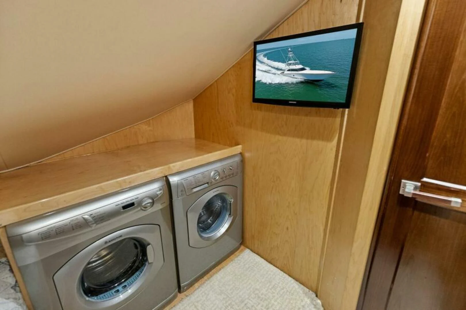 a small room with a television and a washing machine aboard THE PROVIDER Yacht for Sale