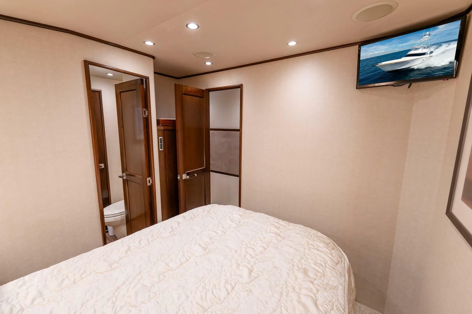 a hotel room with a bed and tv aboard THE PROVIDER Yacht for Sale