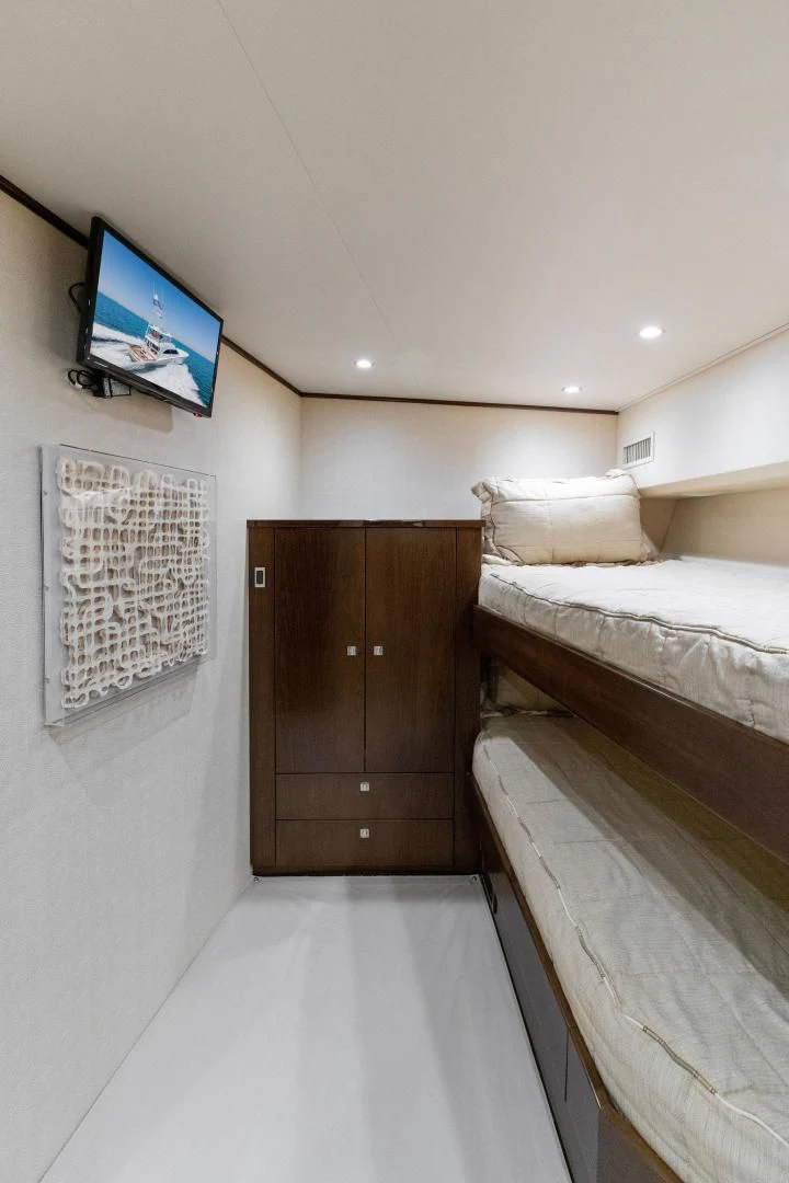 a room with a bed and a tv on the wall aboard THE PROVIDER Yacht for Sale