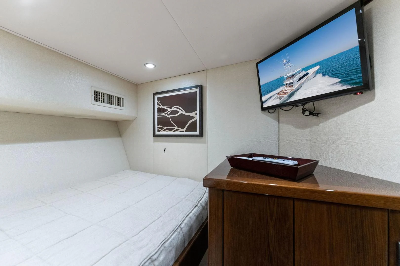 a bed with a television on the wall aboard THE PROVIDER Yacht for Sale