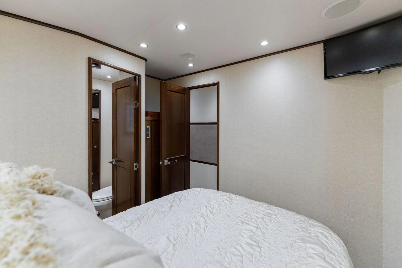 a bedroom with a bed and a television on the wall aboard THE PROVIDER Yacht for Sale