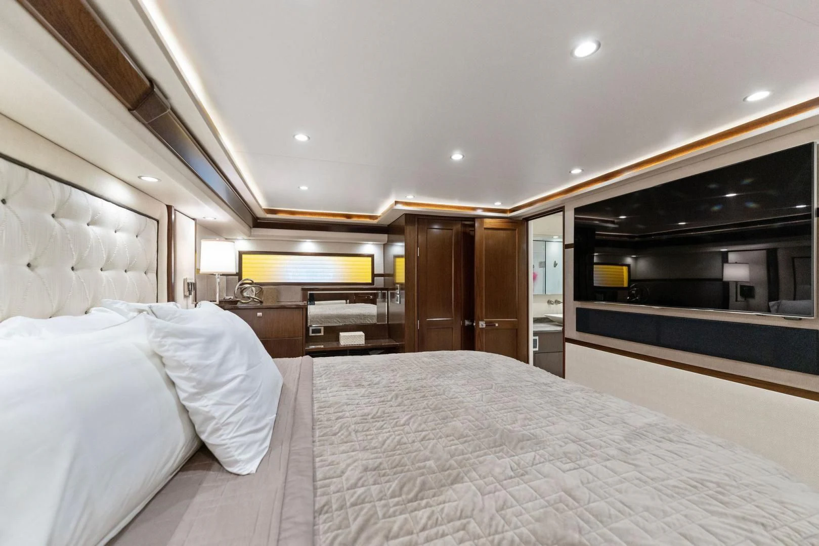 a bedroom with a bed and a television aboard THE PROVIDER Yacht for Sale