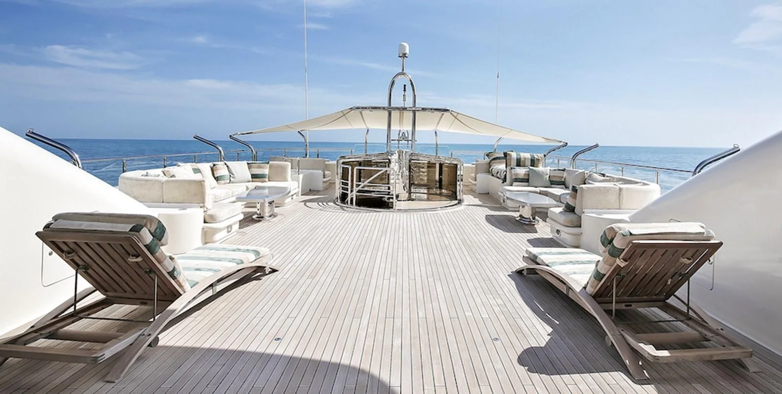 a deck with chairs and a table on it aboard SAMIRA Yacht for Sale