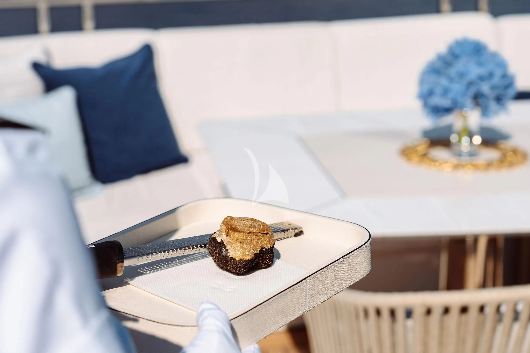 a table with a plate of food and a candle aboard SAMIRA Yacht for Sale