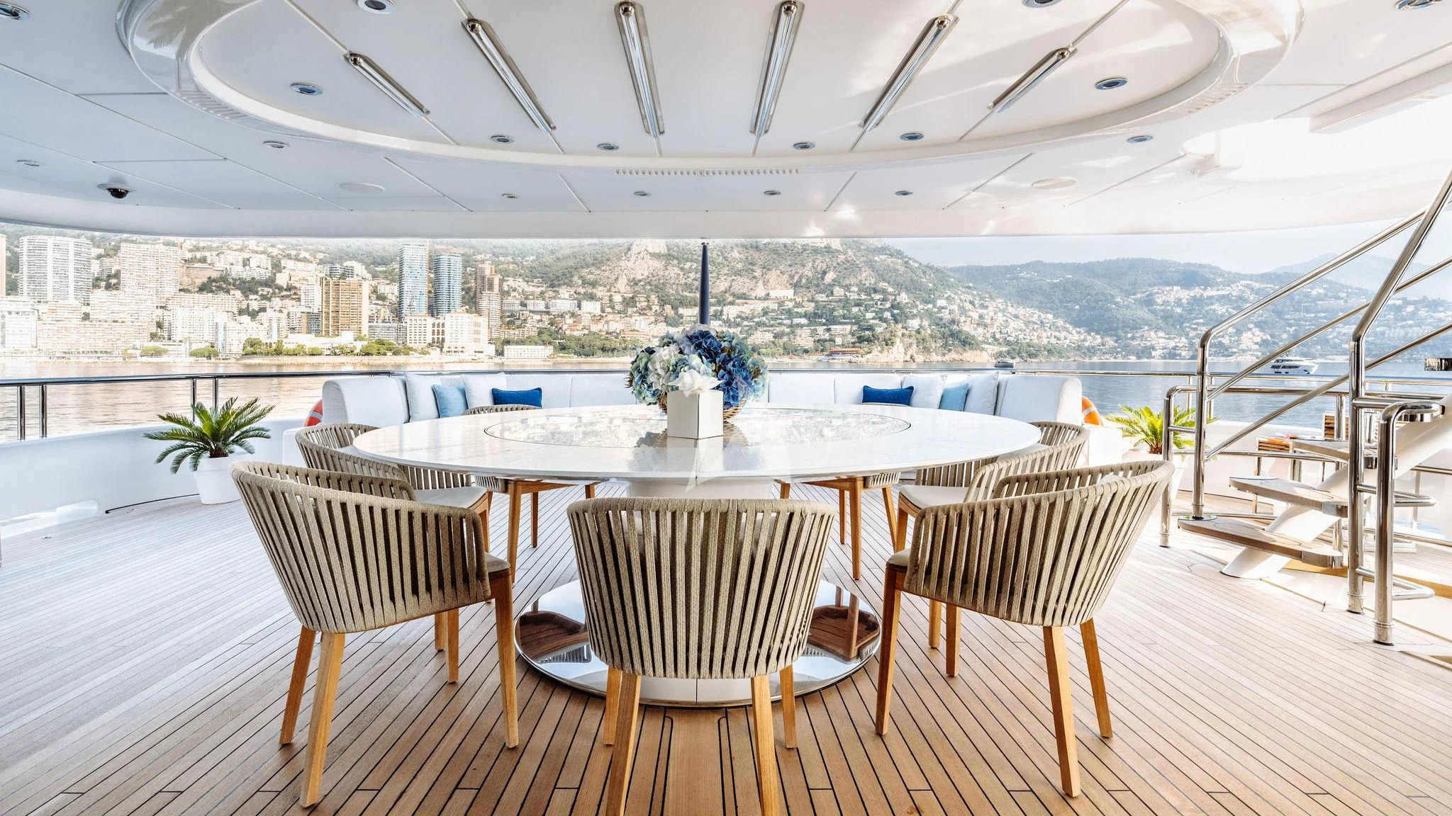 a table and chairs on a patio aboard SAMIRA Yacht for Sale