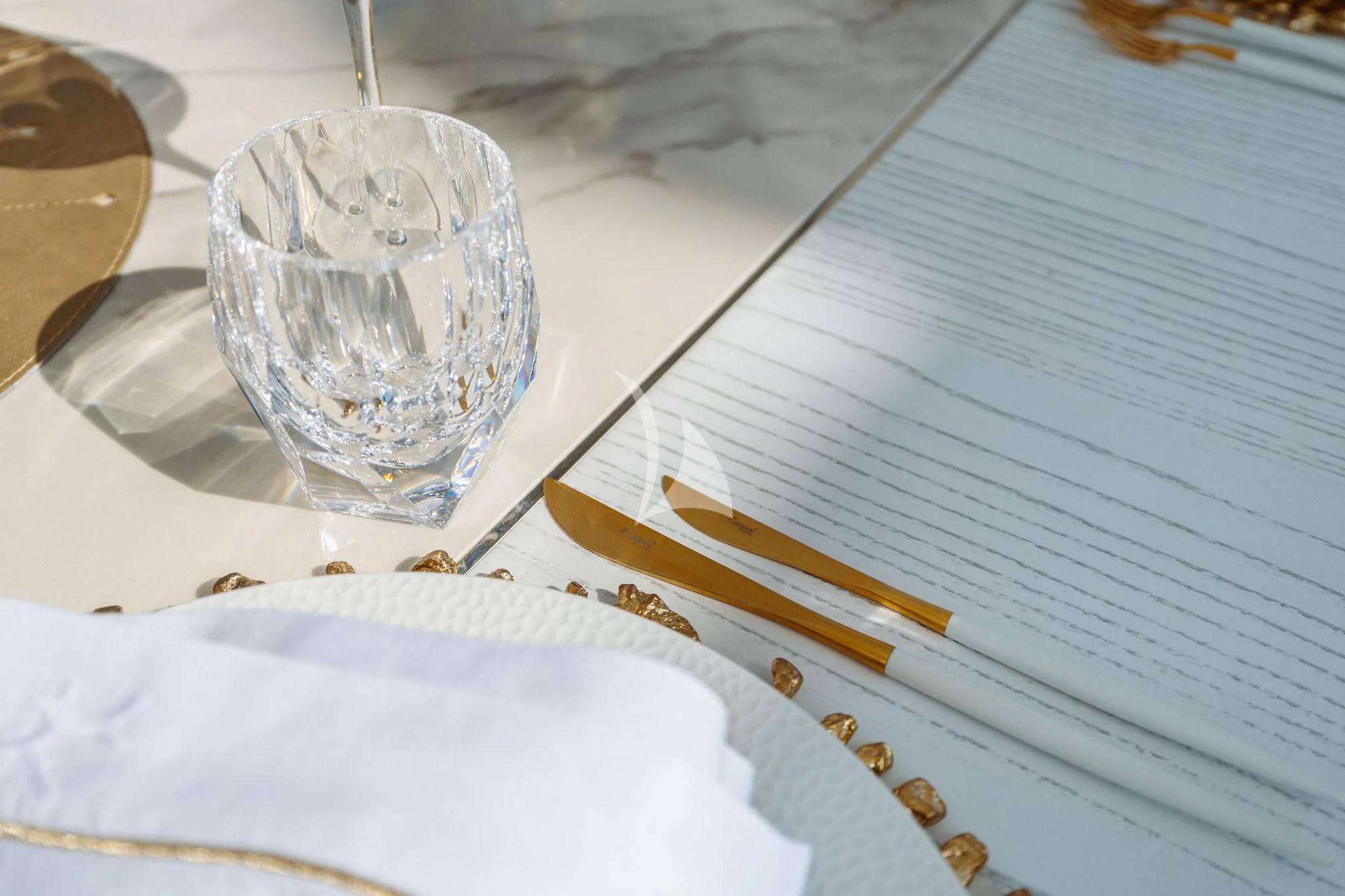 a glass on a table aboard SAMIRA Yacht for Sale